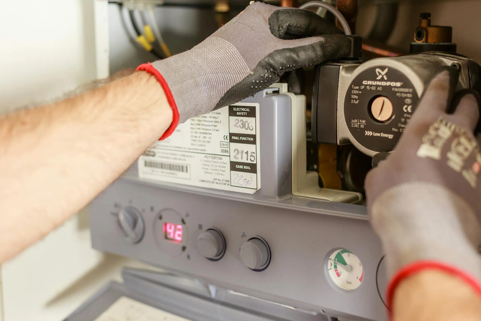 Heating engineer working on a domestic boiler in a Liverpool home